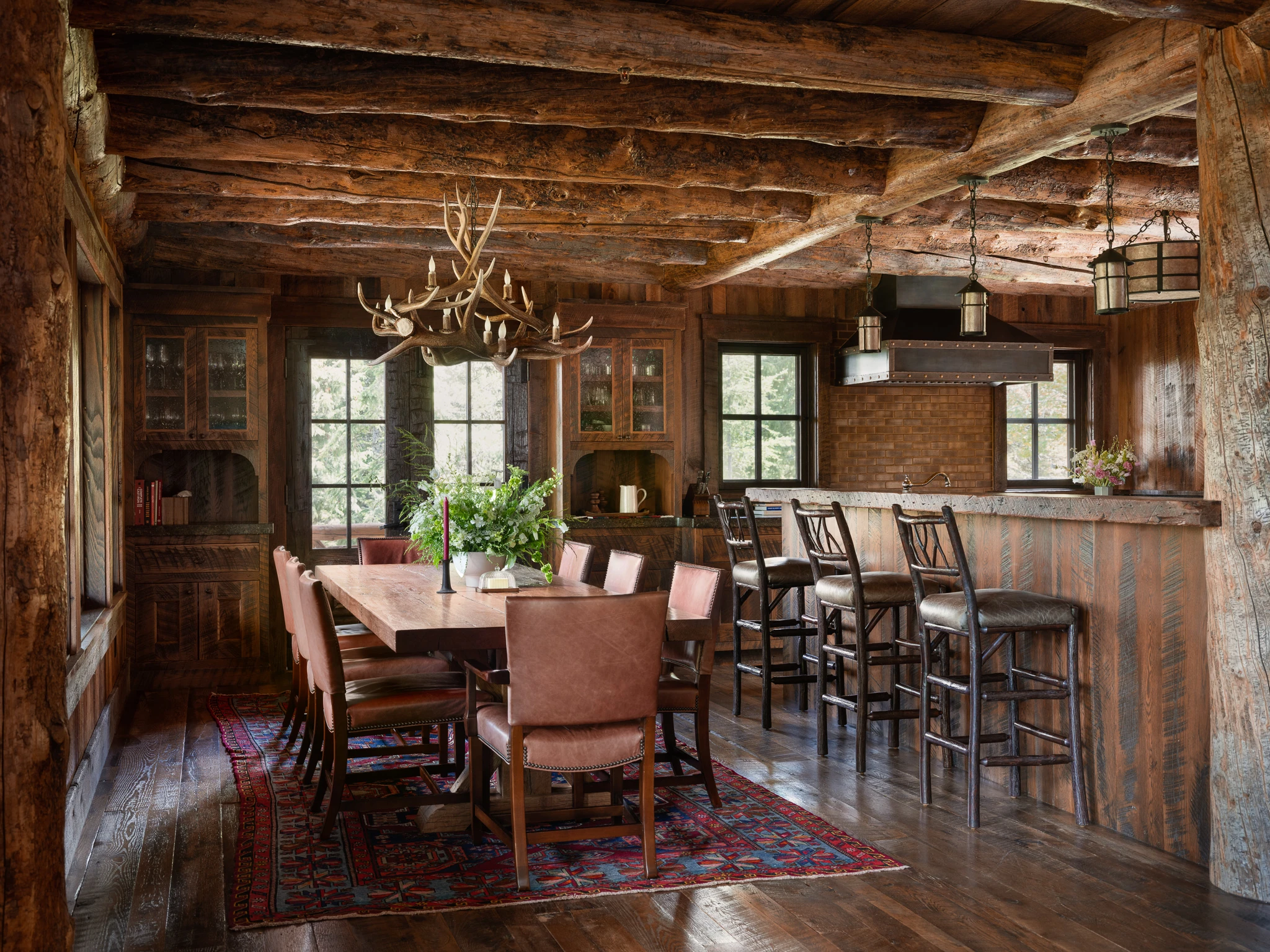 Dining room with antler chandelier — interior design photography Big Sky Montana, Lohss Construction